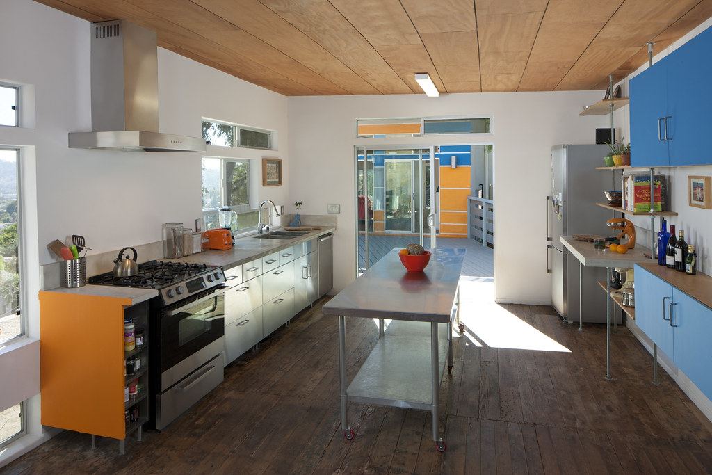 Kitchen interior with island lighting and cabinetry supports Effective Use of Task Pendant and Undercabinet Lighting for Backsplash Visibility by showing the room feature the section discusses.