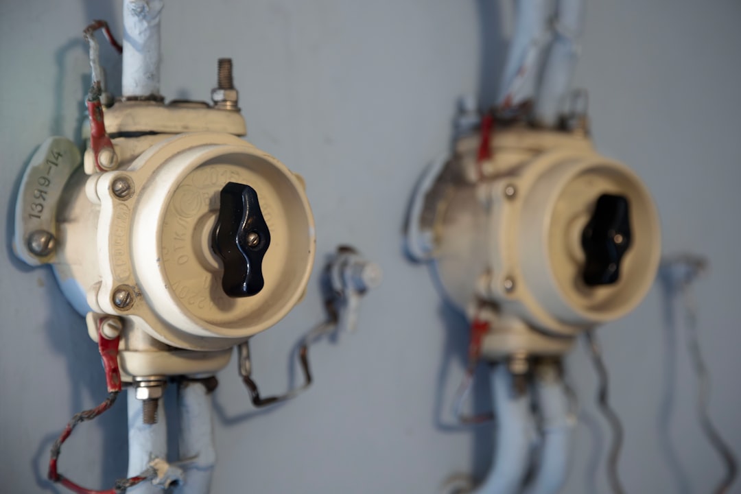 Two old electrical switches are mounted on a wall.