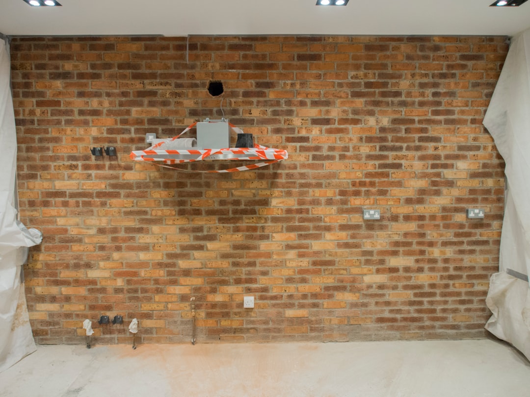 A room with a brick wall and white curtains