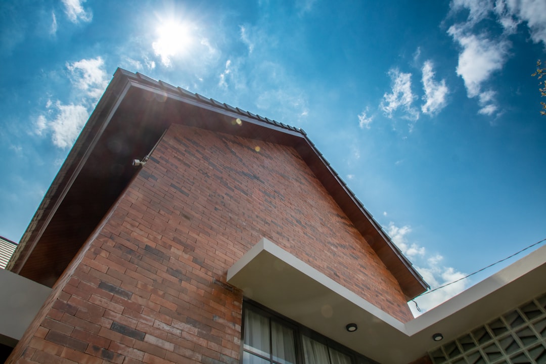 Modern building exterior with brick facade and blue sky