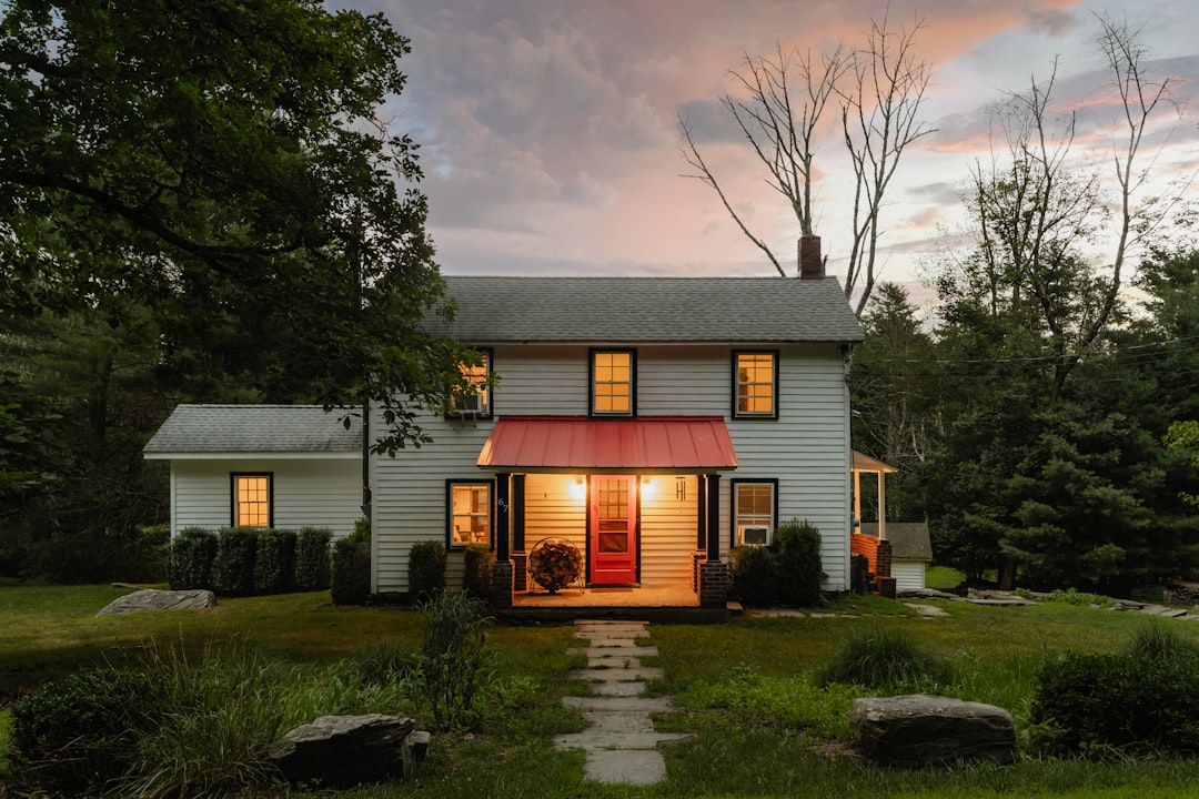 A small white house with a red awning