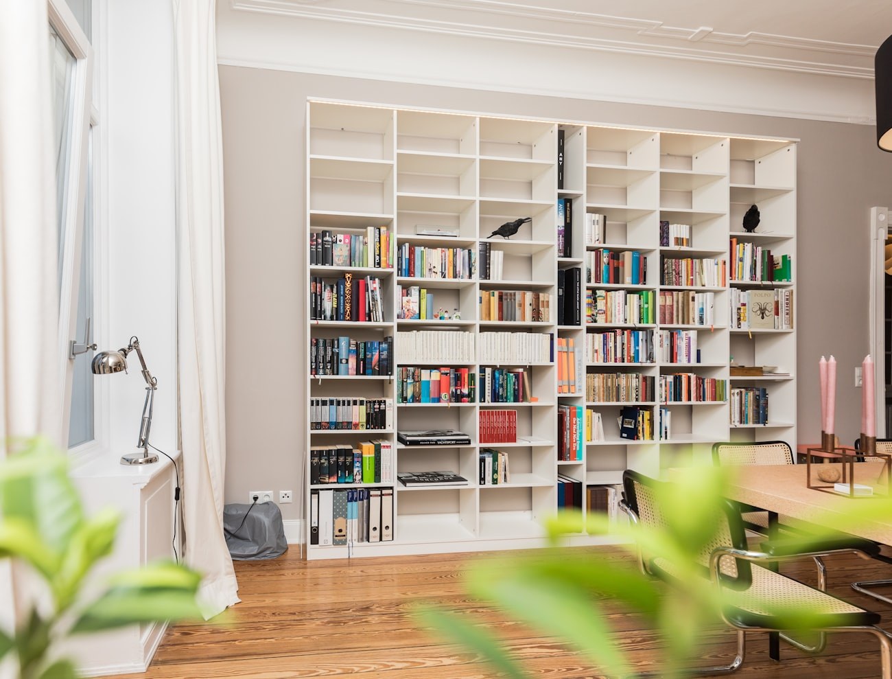 White built-in bookshelves in a home library room