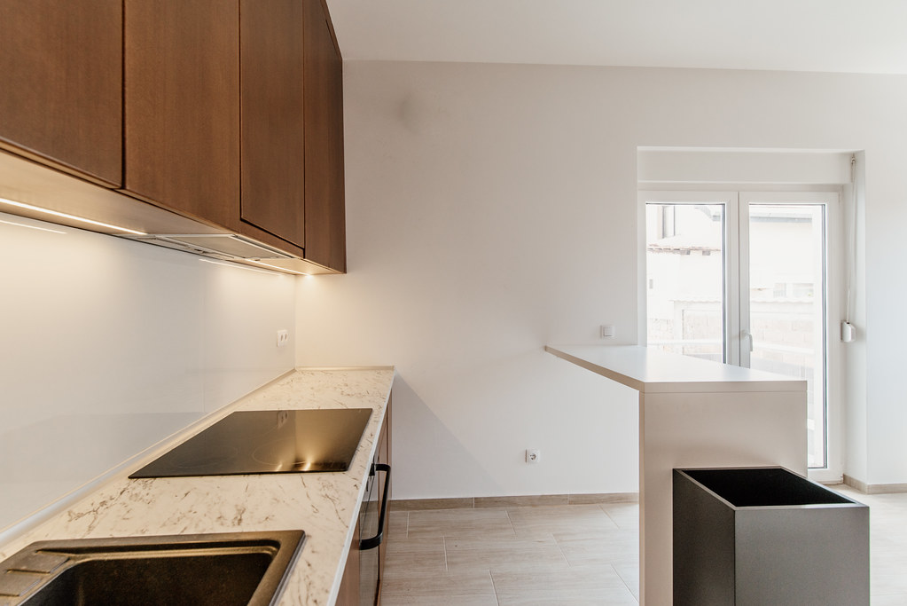 Modern kitchen interior design featuring light colors and minimalist style with sleek cabinets and elegant countertops