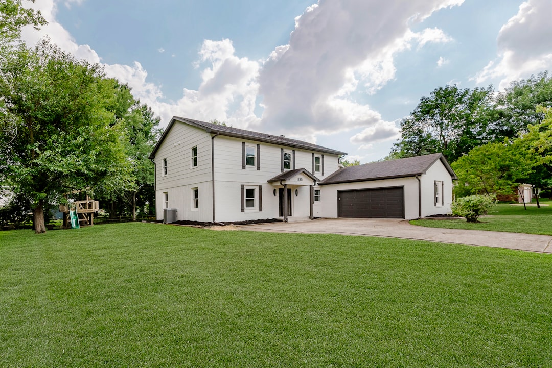A white two-story house with a garage.