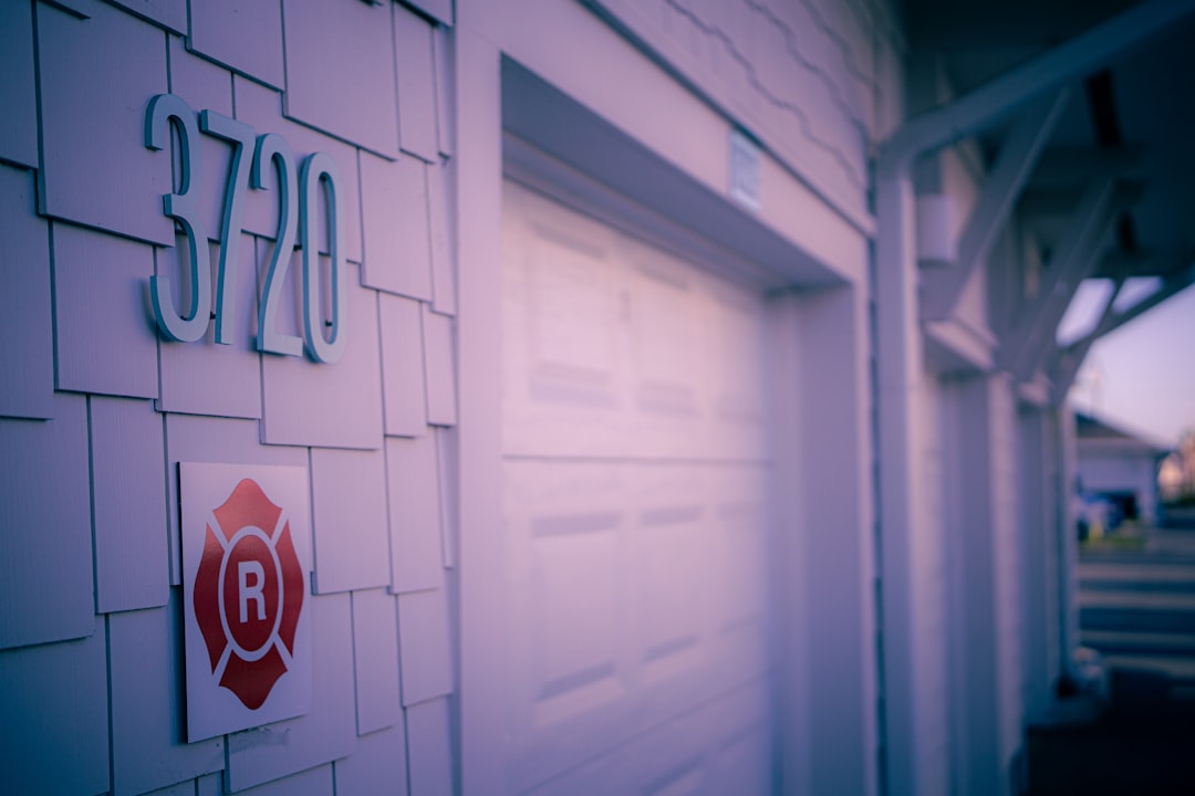 House number 3720 on shingled wall next to garage.