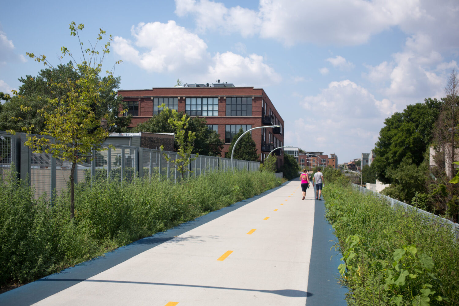 City skyline and public realm planning reference showing elevated greenway trail repurposing historic infrastructure.