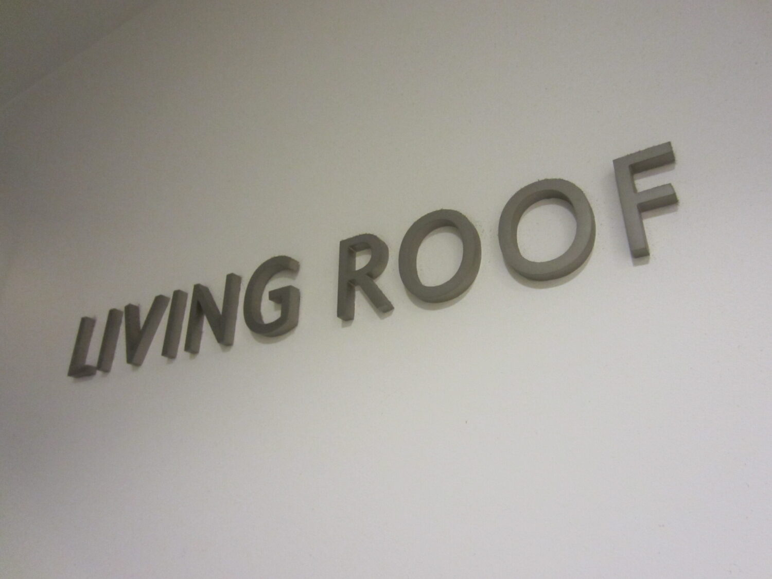 Urban green roof design reference integrating native landscaping and environmentally adaptive building form.