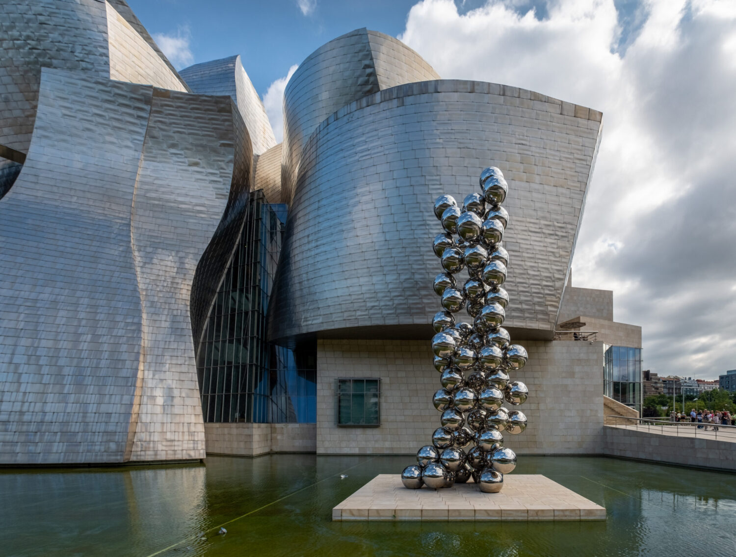Guggenheim Museum Bilbao’s curved titanium facade harmonizes with Bilbao’s urban riverfront.