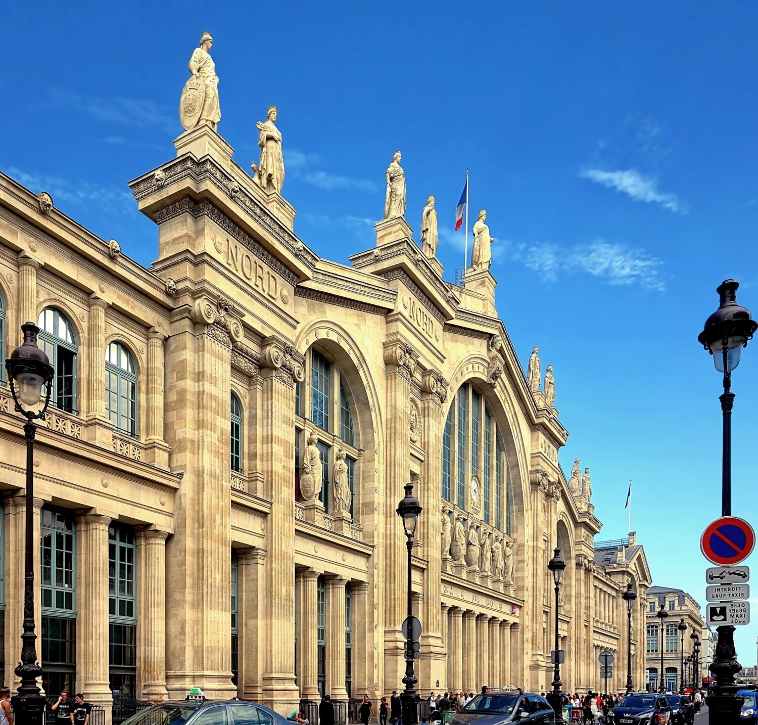 Gare du Nord’s Beaux-Arts sculptural facade and large iron train shed in Paris.