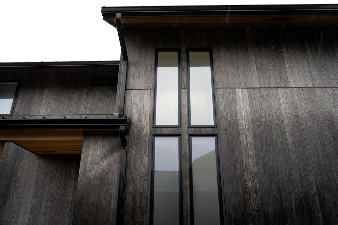 Modern building exterior with tall windows and narrow windows.
