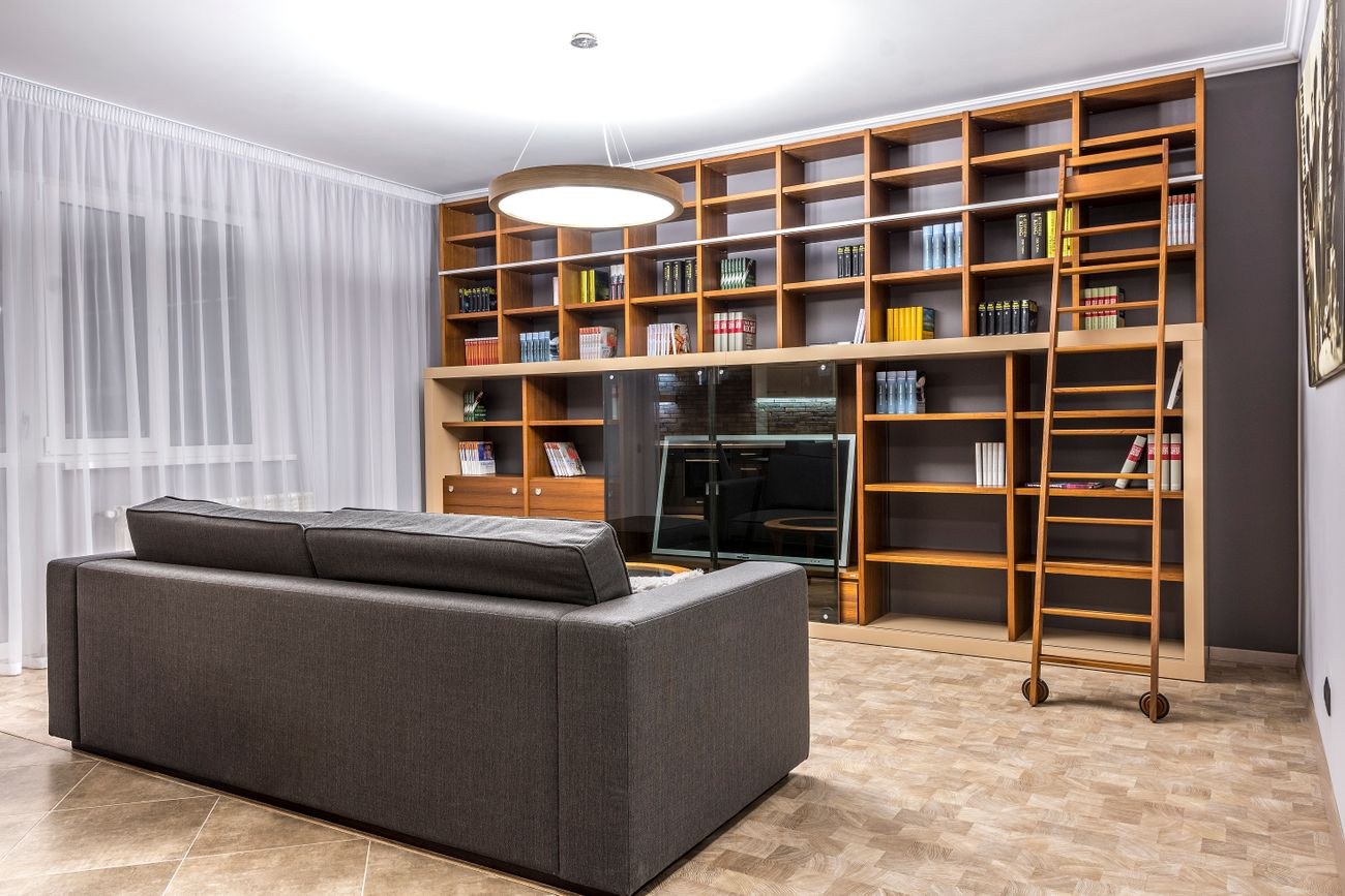 Wooden bookshelves and sofa in a styled living room