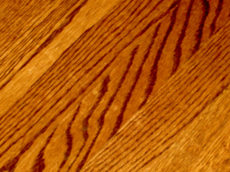 A beautifully polished wood floor with a warm finish, ideal for a cozy home.