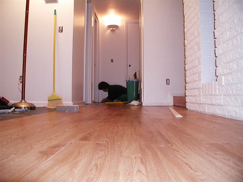 A freshly installed new floor in a spacious room, showcasing a clean aesthetic.
