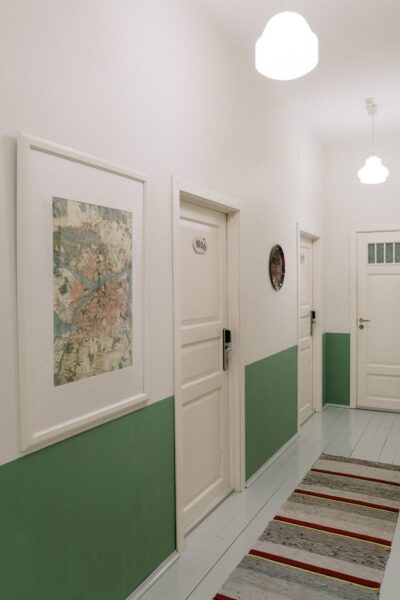 A sleek and minimalist hallway with paintings and modern lighting, perfect for interior design inspiration.