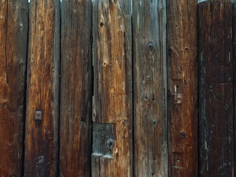 Detailed view of a rustic wooden fence showcasing weathered textures and natural grains.