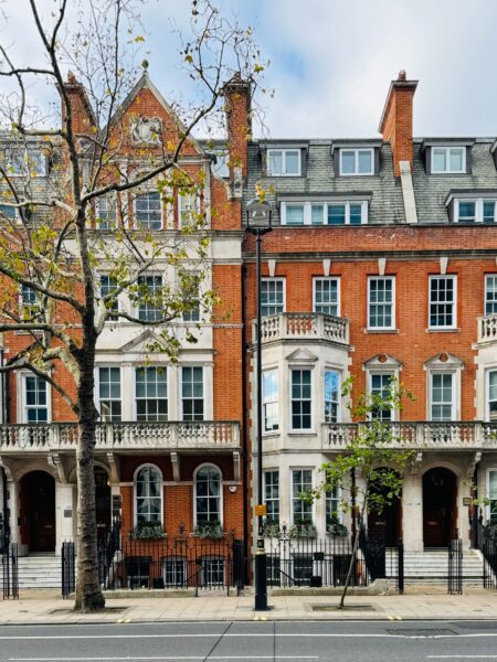 Traditional brick townhouses in London, showcasing iconic British architecture.